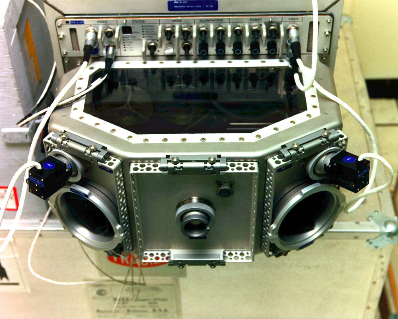 The USML-1 Glovebox (GBX) is a multi-user facility supporting 16 experiments in fluid dynamics, combustion sciences, crystal growth, and technology demonstration. The GBX has an enclosed working space which minimizes the contamination risks to both Spacelab and experiment samples. The GBX supports four charge-coupled device (CCD) cameras (two of which may be operated simultaneously) with three black-and-white and three color camera CCD heads available. The GBX also has a backlight panel, a 35 mm camera, and a stereomicroscope that offers high-magnification viewing of experiment samples. Video data can also be downlinked in real-time. The GBX also provides electrical power for experiment hardware, a time-temperature display, and cleaning supplies.