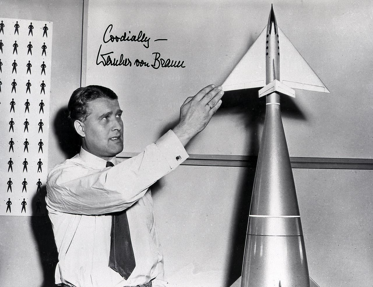 Dr. von Braun stands beside a model of the upper stage (Earth-returnable stage) of the three-stage launch vehicle built for the series of the motion picture productions of space flight produced by Walt Disney in the mid-1950's.