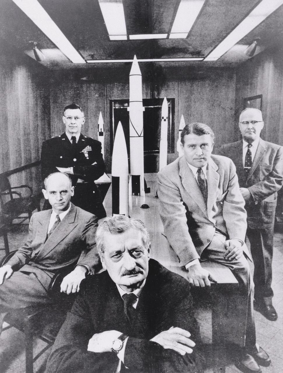 Five pioneers pose with scale models of their missiles they created in the 1950s. From left to right: Dr. Ernst Stuhlinger, a member of the original German rocket team who directed the Research Projects Office, Army Ballistic Missile Agency (ABMA); Major General Holger Toftoy, who consolidated U.S. missile and rocketry development; Professor Herman Oberth, a rocket pioneer and Dr. von Braun's mentor; Dr. Wernher von Braun, Director, Development Operation Division, ABMA; and Dr. Robert Lusser, who served as assistant director for Reliability Engineering for ABMA. This photographis was taken February 1, 1956 by Hank Walker and appeared in February 27, 1956 issue of Life magazine.
