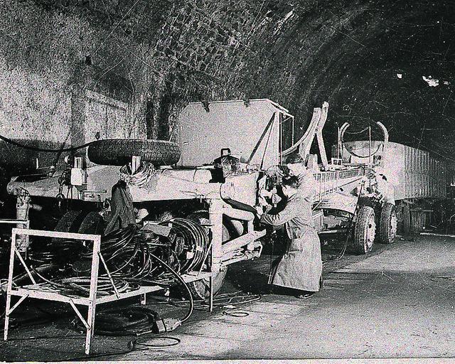 In this photograph from the fall of 1943, German technicians wire vehicles for mobile V-2 batteries in an abandoned railroad turnel in the Rhineland. The team of German engineers and scientists who developed the V-2 came to the United States at the end of World War II and worked for the U. S. Army at Fort Bliss, Texas, and Redstone Arsenal in Huntsville, Alabama.