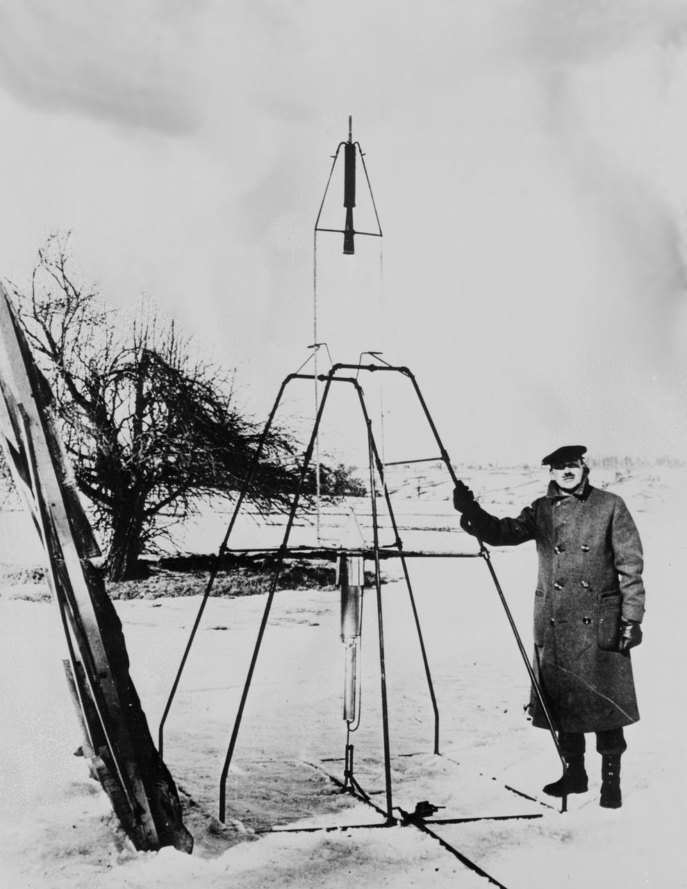 Dr. Robert H. Goddard and liquid oxygen-gasoline rocket in the frame from which it was fired on March 16, 1926, at Auburn, Mass. It flew for only 2.5 seconds, climbed 41 feet, and landed 184 feet away in a cabbage patch. From 1930 to 1941, Dr. Goddard made substantial progress in the development of progressively larger rockets, which attained altitudes of 2400 meters, and refined his equipment for guidance and control, his techniques of welding, and his insulation, pumps, and other associated equipment. In many respects, Dr. Goddard laid the essential foundations of practical rocket technology