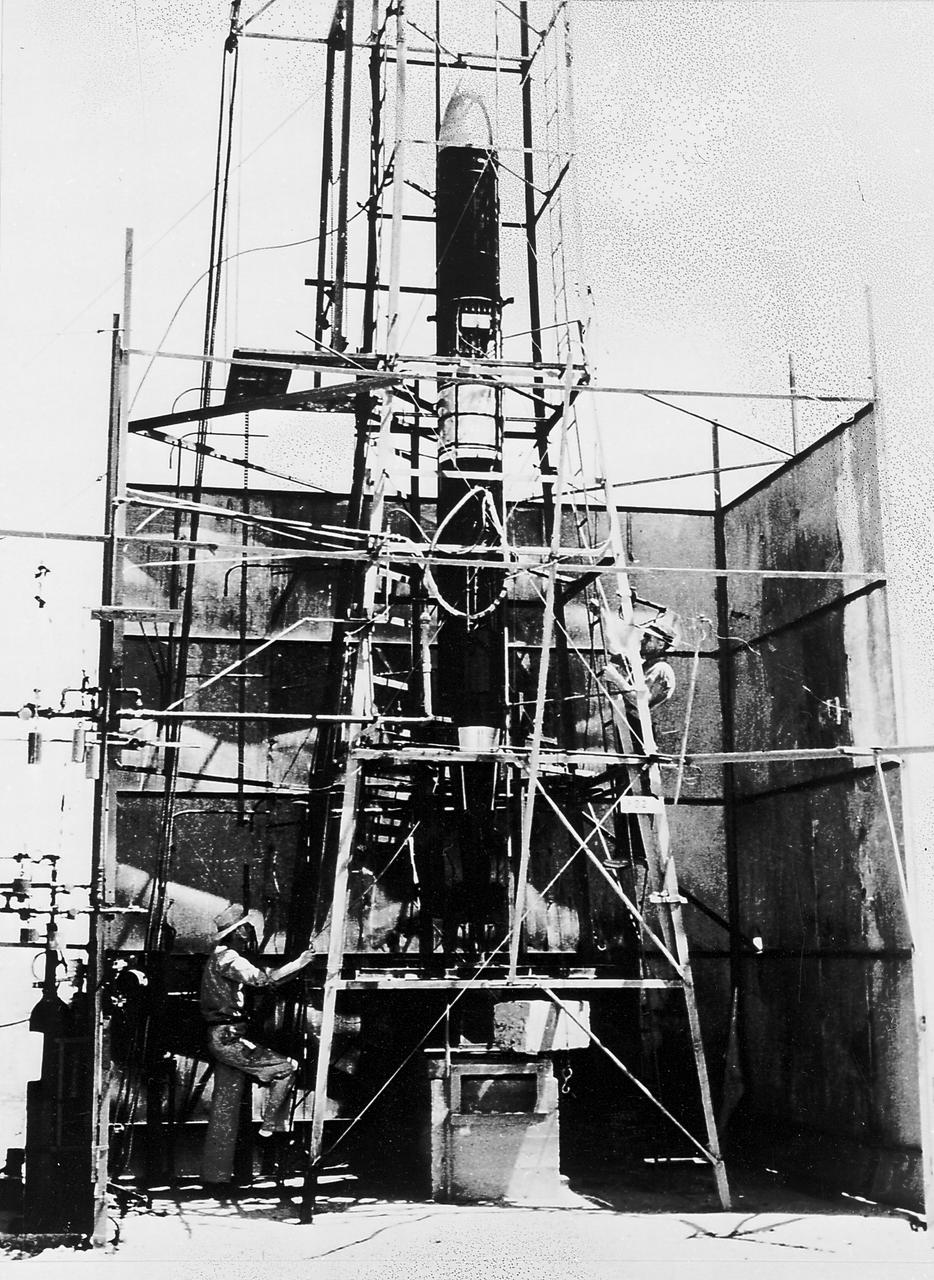 Goddard rocket in launching tower at Roswell, New Mexico, March 21, 1940. Fuel was injected by pumps from the fueling platform at left. From 1930 to 1941, Dr. Goddard made substantial progress in the development of progressively larger rockets, which attained altitudes of 2400 meters, and refined his equipment for guidance and control, his techniques of welding, and his insulation, pumps, and other associated equipment. In many respects, Dr. Goddard laid the essential foundations of practical rocket technology