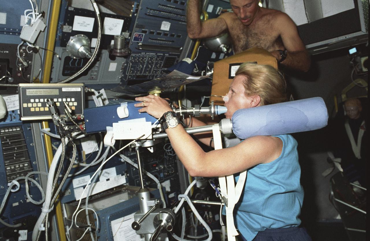 Spacelab Life Science -1 (SLS-1) was the first Spacelab mission dedicated solely to life sciences. The main purpose of the SLS-1 mission was to study the mechanisms, magnitudes, and time courses of certain physiological changes that occur during space flight, to investigate the consequences of the body's adaptation to microgravity and readjustment to Earth's gravity, and bring the benefits back home to Earth. The mission was designed to explore the responses of the heart, lungs, blood vessels, kidneys, and hormone-secreting glands to microgravity and related body fluid shifts; examine the causes of space motion sickness; and study changes in the muscles, bones, and cells. This photograph shows astronaut Rhea Seddon conducting an inflight study of the Cardiovascular Deconditioning experiment by breathing into the cardiovascular rebreathing unit. This experiment focused on the deconditioning of the heart and lungs and changes in cardiopulmonary function that occur upon return to Earth. By using noninvasive techniques of prolonged expiration and rebreathing, investigators can determine the amount of blood pumped out of the heart (cardiac output), the ease with which blood flows through all the vessels (total peripheral resistance), oxygen used and carbon dioxide released by the body, and lung function and volume changes. SLS-1 was launched aboard the Space Shuttle Orbiter Columbia (STS-40) on June 5, 1995.