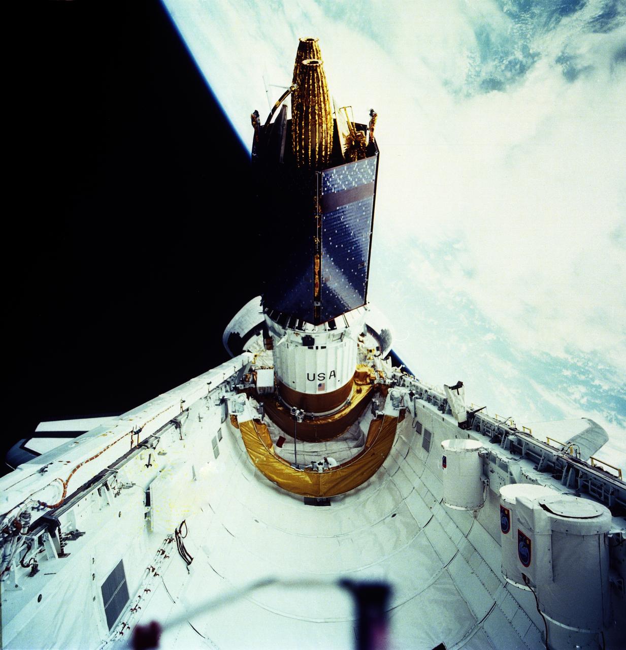 The primary payload of the STS-43 mission, Tracking and Data Relay Satellite-E (TDRS-E) attached to an Inertial Upper Stage (IUS) was photographed at the moment of its release from the cargo bay of the Space Shuttle Orbiter Atlantis. The TDRS-E was boosted by the IUS into geosynchronous orbit and positioned to remain stationary 22,400 miles above the Pacific Ocean southwest of Hawaii. The TDRS system provides almost uninterrupted communications with Earth-orbiting Shuttles and satellites, and had replaced the intermittent coverage provided by globe-encircling ground tracking stations used during the early space program. The TDRS can transmit and receive data, and track a user spacecraft in a low Earth orbit. The IUS is an unmarned transportation system designed to ferry payloads from low Earth orbit to higher orbits that are unattainable by the Shuttle. The launch of STS-43 occurred on August 2, 1991.