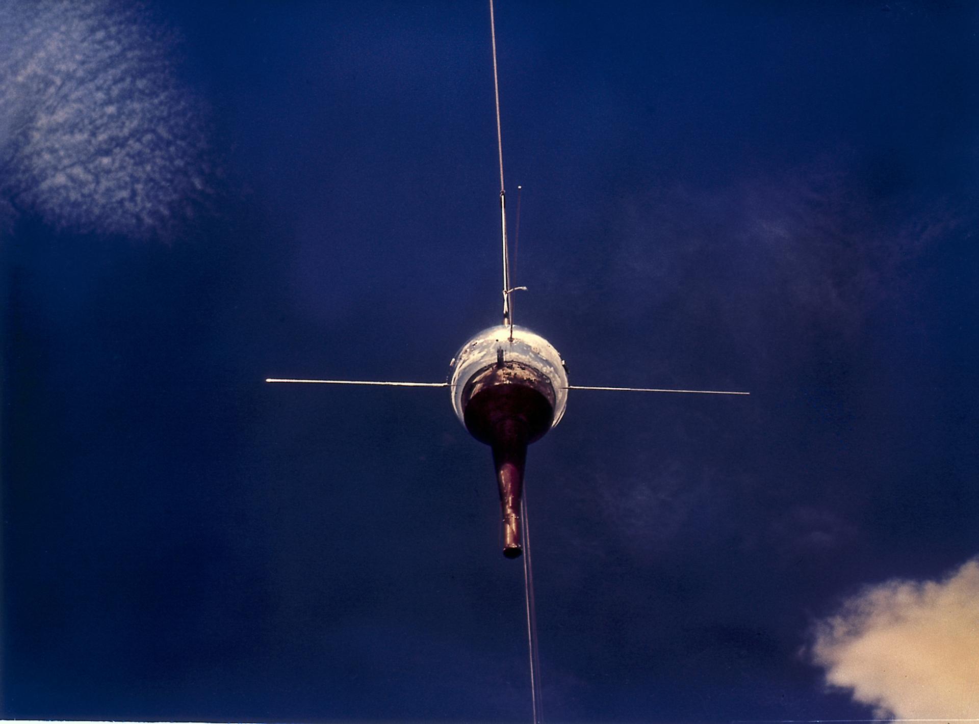 View of the Vanguard III satellite against the backdrop of a deep blue sky.