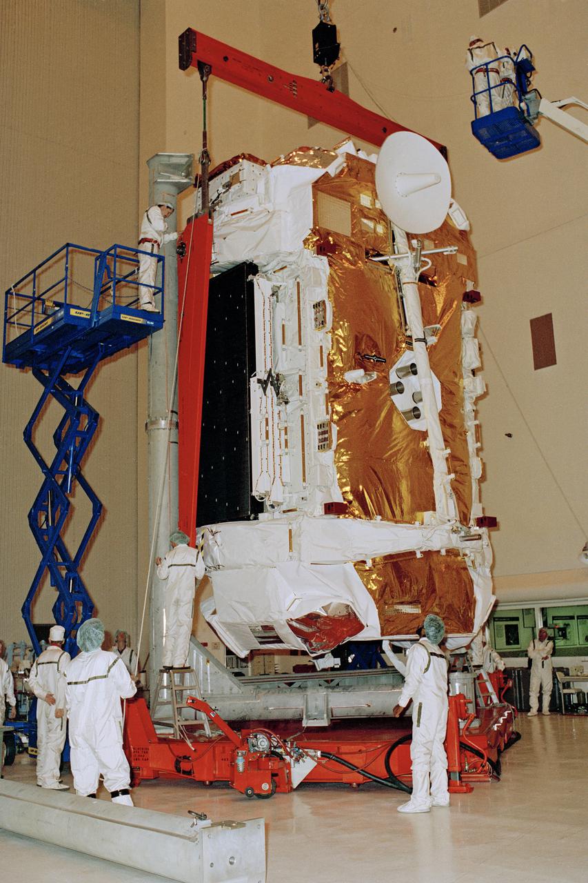 CAPE CANAVERAL, Fla. -- In the Payload Hazardous Servicing Facility at the Kennedy Space Center in Florida, technicians tilt the massive Gamma ray Observatory GRO upright for installation onto the transporter which will carry it to the Vertical Processing Facility. The spacecraft is scheduled to fly aboard the space shuttle Atlantis on STS-37. As the second of four great observatories planned by NASA, GRO will study the celestial gamma rays believed to be a record of cosmic change and evolution. Photo Credit: NASA