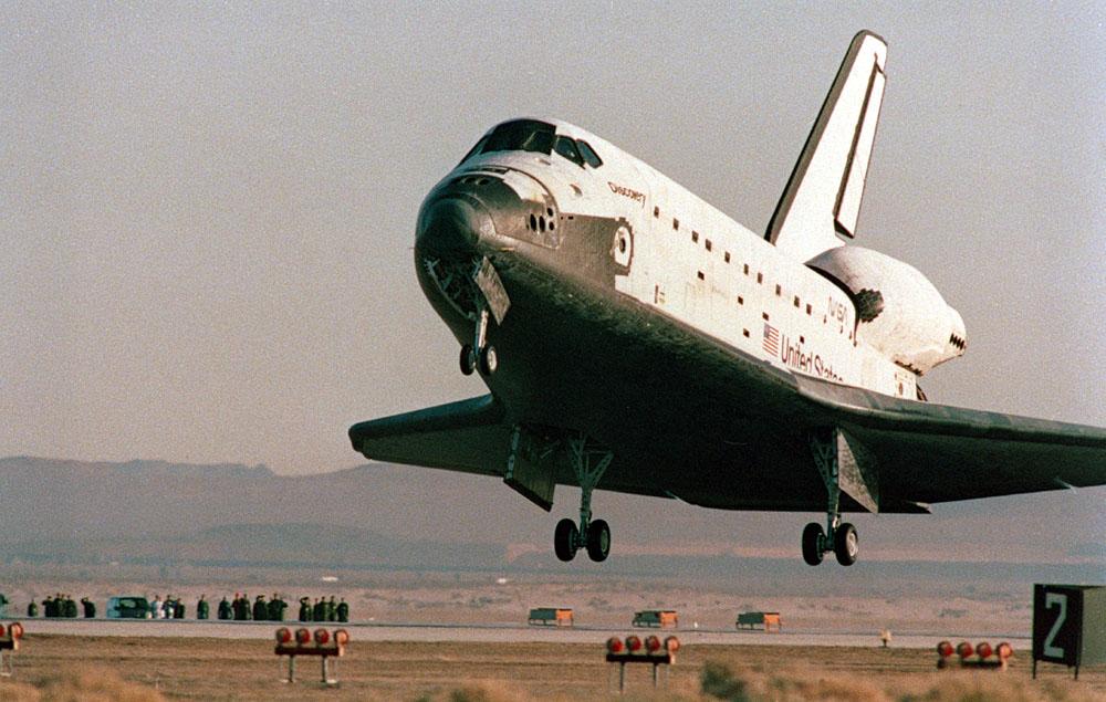 Space Shuttle Discovery STS-42) is just about to ease down its main gear on Runway 22 at Edwards Air Force Base in southern California. The successful landing completed an eight-day mission for five NASA astronauts and two payload specialists supporting the first International Microgravity Laboratory (IML-1) mission.