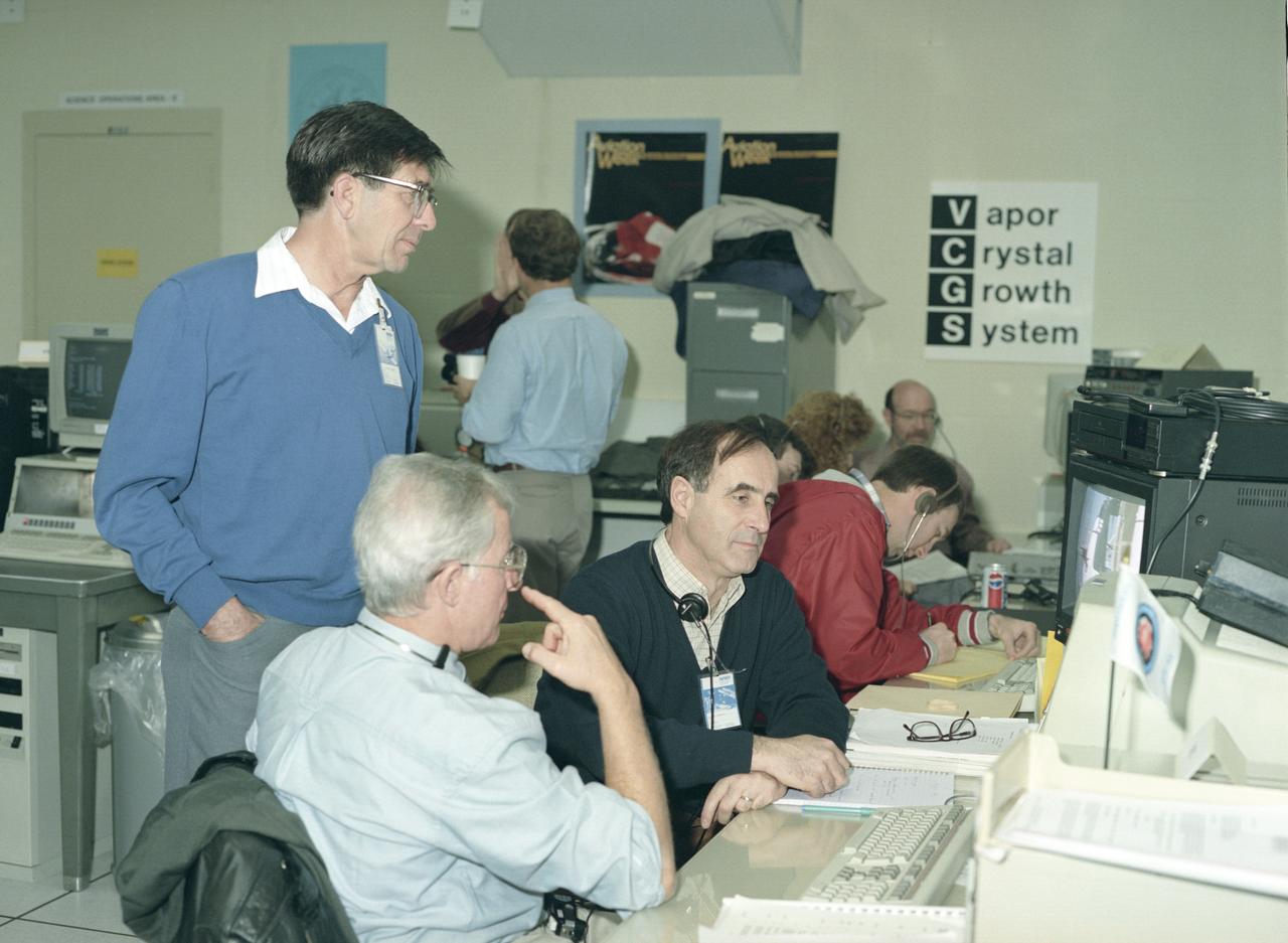 The primary payload for Space Shuttle Mission STS-42, launched January 22, 1992, was the International Microgravity Laboratory-1 (IML-1), a pressurized manned Spacelab module. The goal of IML-1 was to explore in depth the complex effects of weightlessness of living organisms and materials processing. Around-the-clock research was performed on the human nervous system's adaptation to low gravity and effects of microgravity on other life forms such as shrimp eggs, lentil seedlings, fruit fly eggs, and bacteria. Materials processing experiments were also conducted, including crystal growth from a variety of substances such as enzymes, mercury iodide, and a virus. The Huntsville Operations Support Center (HOSC) Spacelab Payload Operations Control Center (SL POCC) at the Marshall Space Flight Center (MSFC) was the air/ground communication channel used between the astronauts and ground control teams during the Spacelab missions. Featured is the Vapor Crystal Growth System (VCGS) team in SL POCC), during STS-42, IML-1 mission.   