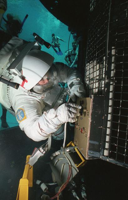 STS-61 astronauts practice installing the corrective optics module on a Hubble Space Telescope mockup in Marshall Space Flight Center's Neutral Buoyancy Simulator. Test activities for STS-61 were carried out at Marshall from June 21, 1993 through July 2, 1993 and again in October 1993.