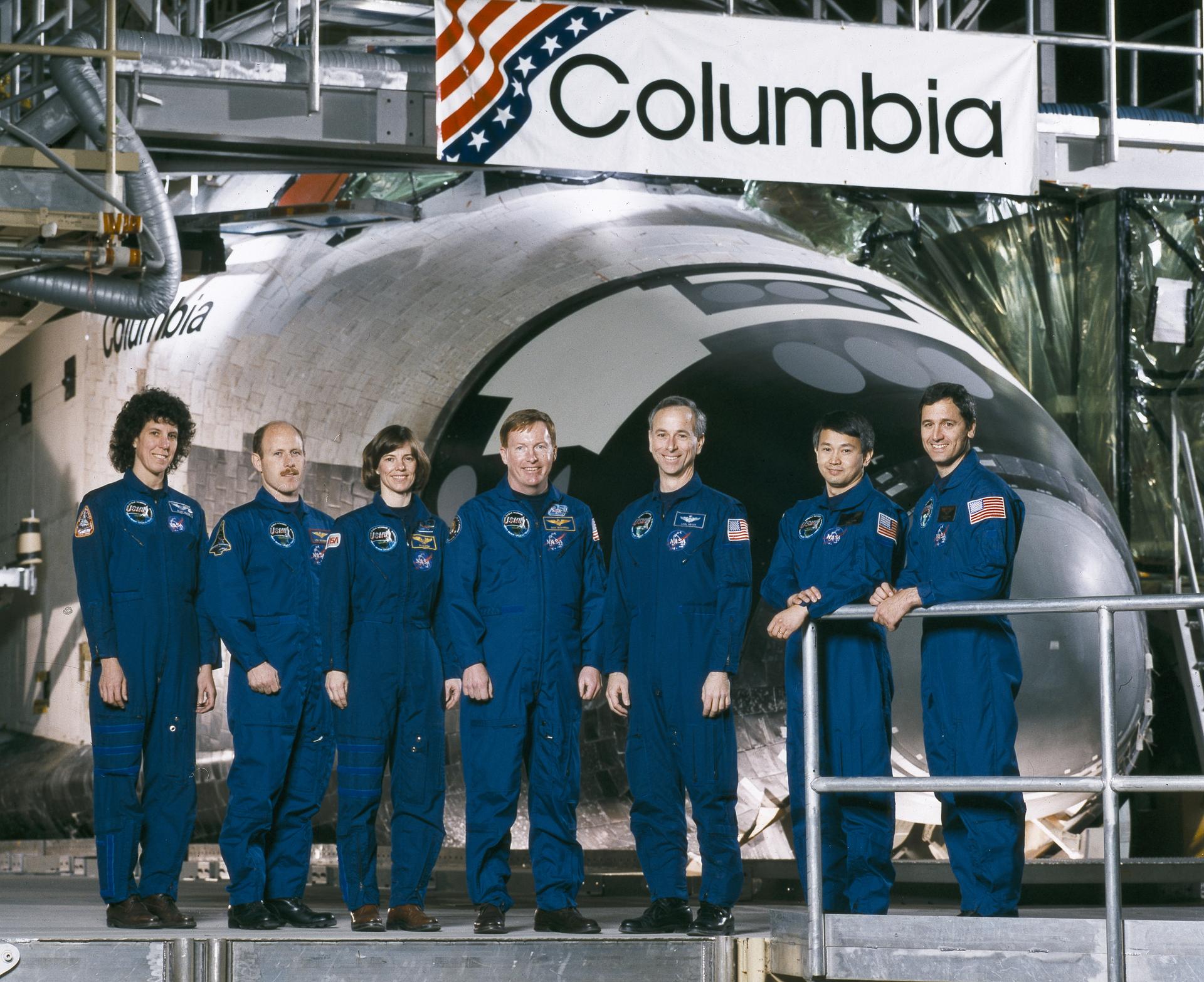 Seven members of the STS-50 crew pose for crew portrait in front of Columbia space shuttle.