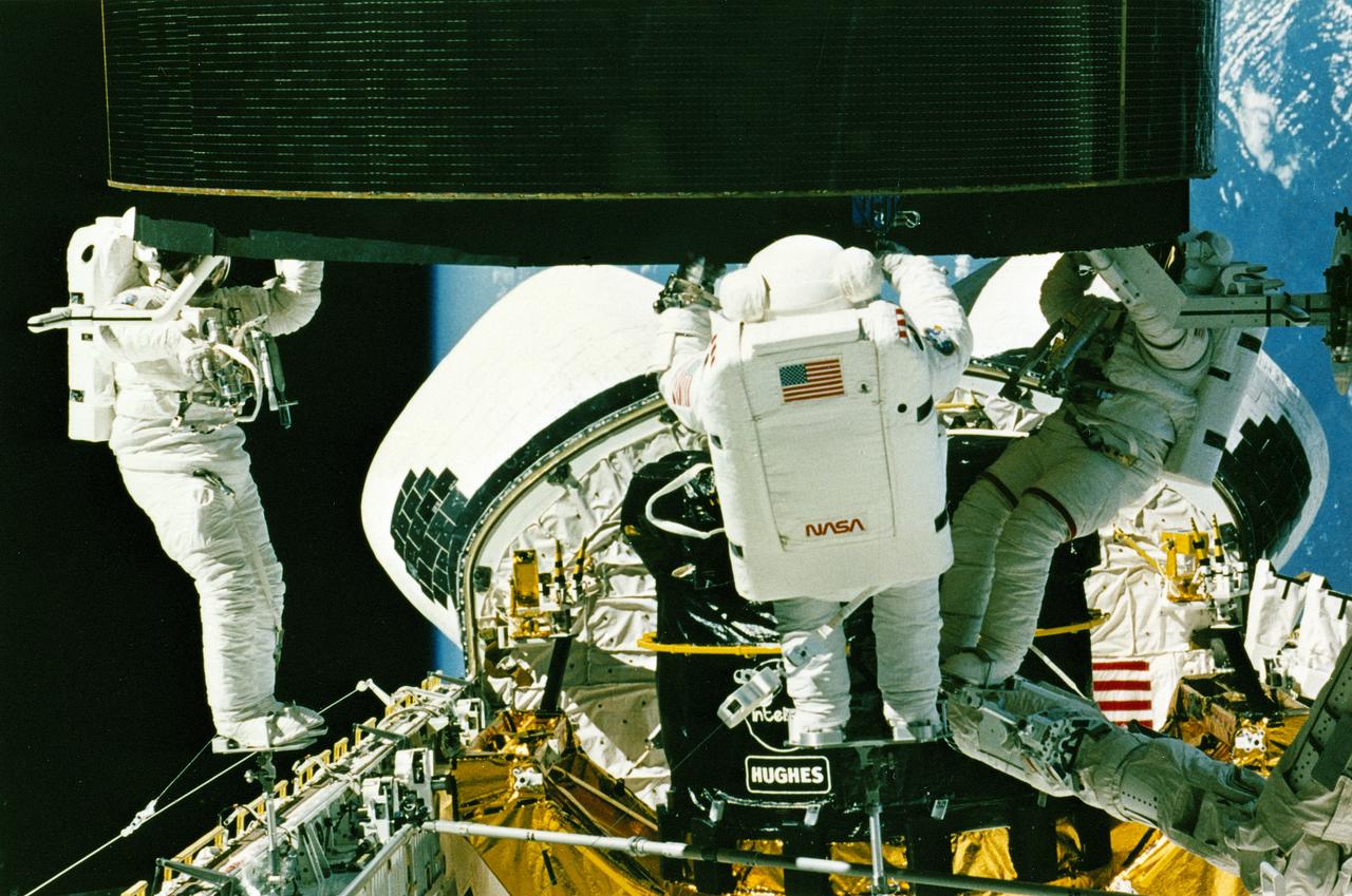 STS-49, the first flight of the Space Shuttle Orbiter Endeavour, lifted off from launch pad 39B on May 7, 1992 at 6:40 pm CDT. The STS-49 mission was the first U.S. orbital flight to feature 4 extravehicular activities (EVAs), and the first flight to involve 3 crew members working simultaneously outside of the spacecraft. The primary objective was the capture and redeployment of the INTELSAT VI (F-3), a communication satellite for the International Telecommunication Satellite organization, which was stranded in an unusable orbit since its launch aboard the Titan rocket in March 1990. In this onboard photo, astronauts Hieb, Akers, and Thuot have handholds on the satellite.