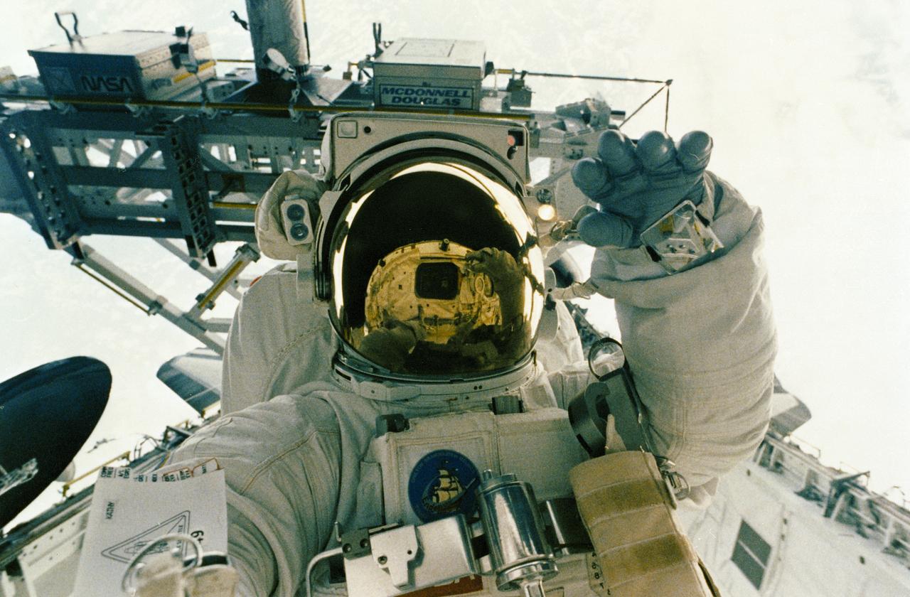 STS-49, the first flight of the Space Shuttle Orbiter Endeavour, lifted off from launch pad 39B on May 7, 1992 at 6:40 pm CDT. The STS-49 mission was the first U.S. orbital flight to feature 4 extravehicular activities (EVAs), and the first flight to involve 3 crew members working simultaneously outside of the spacecraft. The primary objective was the capture and redeployment of the INTELSAT VI (F-3), a communication satellite for the International Telecommunication Satellite organization, which was stranded in an unusable orbit since its launch aboard the Titan rocket in March 1990. In this onboard photo, astronaut Kathryn Thornton is working on the Assembly of Station by EVA Methods (ASEM) in the cargo bay.