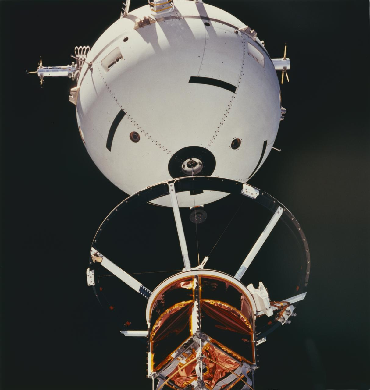 A crewmember aboard the Space Shuttle Orbiter Atlantis (STS-46) used a 70mm handheld camera to capture this medium closeup view of early operations with the Tethered Satellite System (TSS). TSS-1 is being deployed from its boom as it is perched above the cargo bay of the Earth-orbiting Shuttle circling the Earth at an altitude of 296 kilometers (184 miles), the TSS-1 will be well within the tenuous, electrically charged layer of the atmosphere known as the ionosphere. There, a satellite attached to the orbiter by a thin conducting cord, or tether, will be reeled from the Shuttle payload bay. On this mission the satellite was plarned to be deployed 20 kilometers (12.5 miles) above the Shuttle. The conducting tether will generate high voltage and electrical currents as it moves through the atmosphere allowing scientists to examine the electrodynamics of a conducting tether system. These studies will not only increase our understanding of physical processes in the near-Earth space environment, but will also help provide an explanation for events witnessed elsewhere in the solar system. The crew of the STS-46 mission were unable to reel the satellite as planned. After several unsuccessful attempts, they were only able to extend the satellite 9.8 kilometers (6.1 miles). The TSS was a cooperative development effort by the Italian Space Agency (ASI), and NASA.