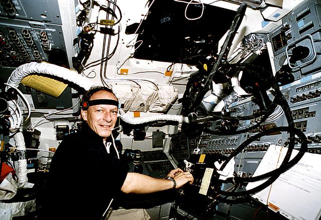 This Space Shuttle Orbiter Atlantis (STS-46) onboard photo shows Swiss scientist Claude Nicollier of the European Space Agency (ESA) supporting the Tether Opitical Phenomena (TOP) activities on the flight deck. The Tethered Satellite System (TSS) was a cooperative development effort by the Italian Space Agency (ASI) and NASA made capable of deploying and retrieving a satellite which is attached by a wire tether from distances up to 100 km from the Orbiter. These free-flying satellites are used as observation platforms outside of the Orbiter.
