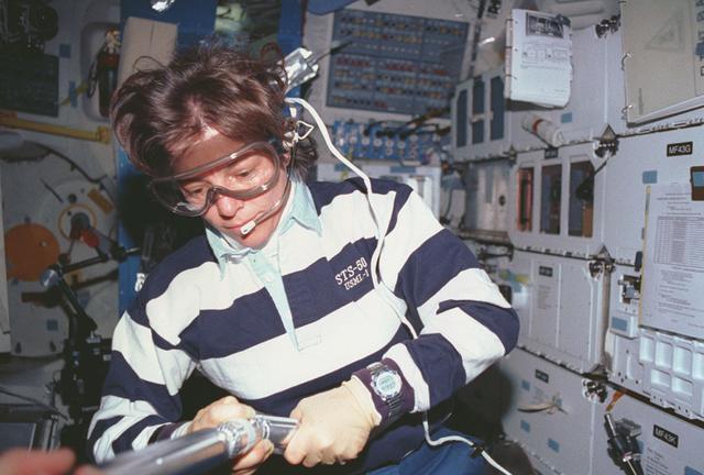Space Shuttle Columbia (STS-50) astronaut Bornie Dunbar wears protective goggles to assemble a zeolite sample cartridge for the Crystal Growth Furnace (CGF) in the United States Microgravity Laboratory-1 (USML-1) science module.