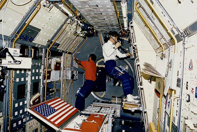 Space Shuttle Columbia (STS-50) onboard photo of astronauts working in United States Microgravity Laboratory (USML-1). USML-1 will fly in orbit for extended periods of time attached to the Shuttle, providing greater opportunities for research in materials science, fluid dynamics, biotechnology, and combustion science. The scientific data gained from the USML-1 missions will constitute a landmark in space science, pioneering investigations into the role of gravity in a wide array of important processes and phenomena. In addition, the missions will also provide much of the experience in performing research in space and in the design of instruments needed for Space Station Freedom and the programs to follow in the 21st Century.