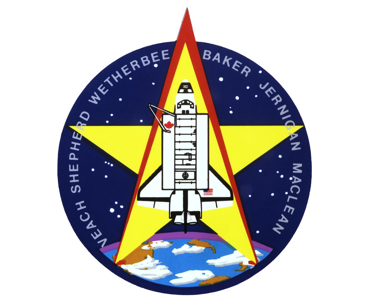 The STS-52 insignia, designed by the mission’s crew members, features a large gold star to symbolize the crew's mission on the frontiers of space. A gold star is often used to symbolize the frontier period of the American West. The red star in the shape of the Greek letter lambda represents both the laser measurements taken from the Laser Geodynamic Satellite (LAGEOS II) and the Lambda Point Experiment, which was part of the United States Microgravity Payload (USMP-l). The remote manipulator and maple leaf are emblematic of the Canadian payload specialist who conducted a series of Canadian flight experiments (CANEX-2), including the Space Vision System test. 