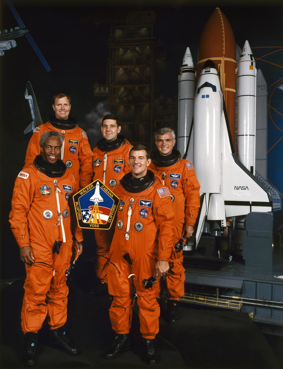 KENNEDY SPACE CENTER, FLA. --  STS053-(S)-002 -- STS-53 Crew Portrait -- These five astronauts have been assigned to fly aboard the Space Shuttle Discovery for the STS-53 mission, scheduled for launch in November of this year.  Pictured are, left to right (front), Guion S. Bluford and James S. Voss, mission specialists; and (back row) David M. Walker, mission commander; Robert D. Cabana, pilot; and Michael R.U. (Rich) Clifford, mission specialist.  The photograph was made in the new Space Center Houston facility