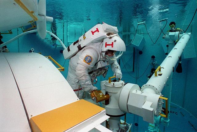 This photograph was taken in the Marshall Space Flight Center (MSFC) Neutral Buoyancy Simulator (NBS) during the testing of the Japanese Experimental Module. The NBS provided the weightless environment encountered in space needed for testing and the practices of extra-vehicular activities.