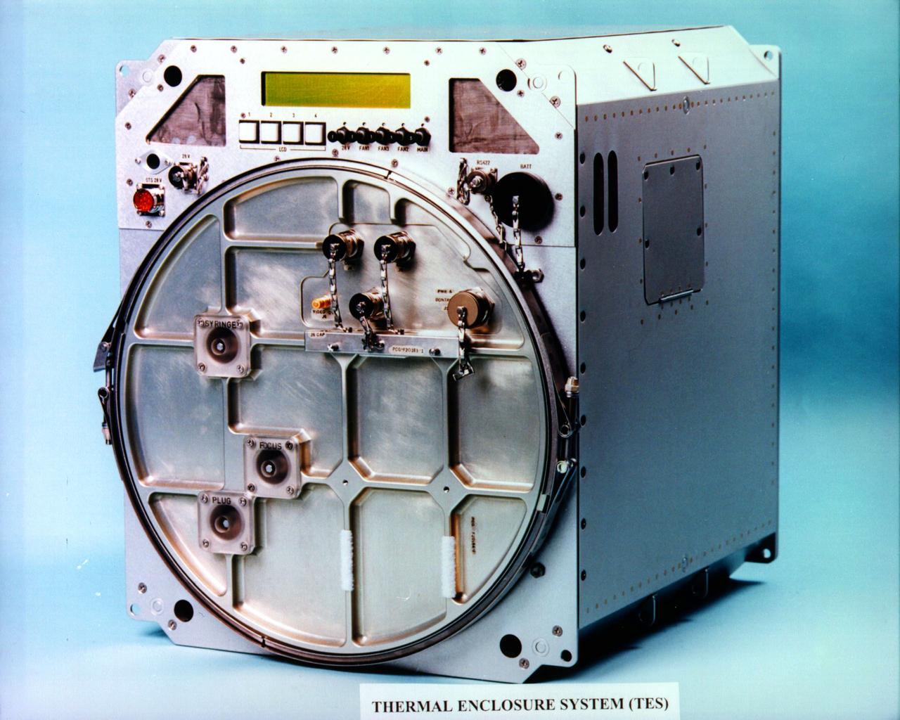 The Thermal Enclosure System (TES) provides thermal control for protein crystal growth experiments. The TES, housed in two middeck lockers on board the Space Shuttle, contains four Vapor Diffusion Apparatus (VDA) trays. Each can act as either a refrigerator or an incubator and its temperature can be controlled to within one-tenth degree C. The first flight of the TES was during USMP-2 (STS-62).