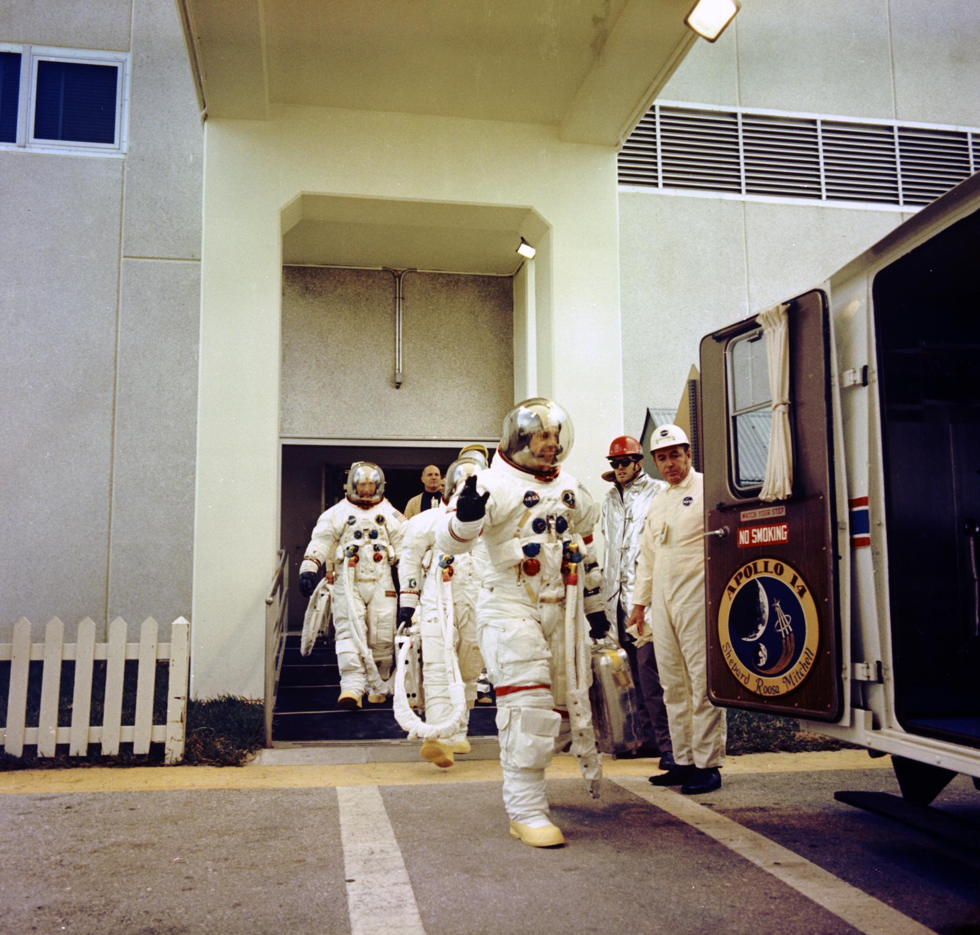 The Apollo 14 astronauts walk out to the transfer van on launch day.