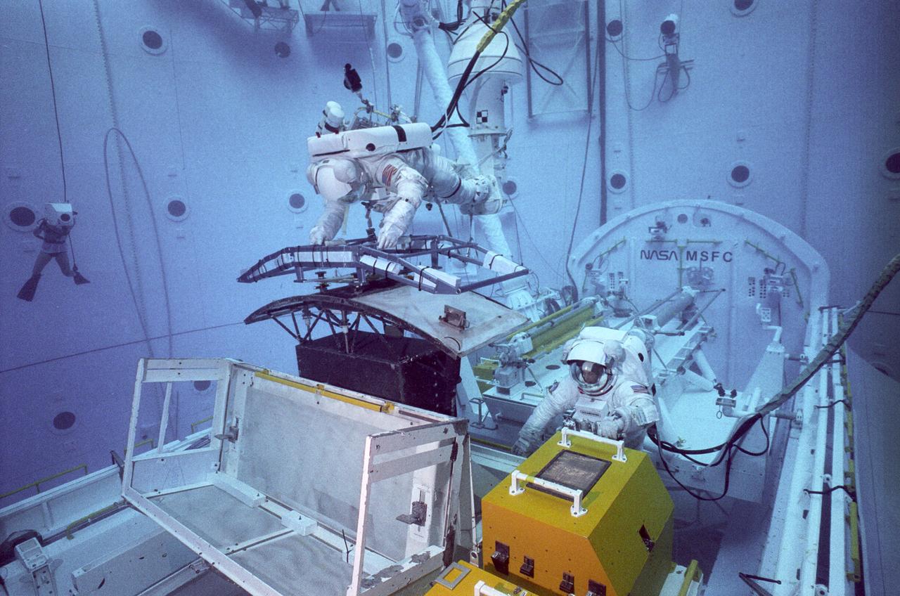 Underwater crew training is conducted in Marshall's Neutral Buoyancy Simulator (NBS) in preparation for on-orbit Hubble Space Telescope (HST) operations.