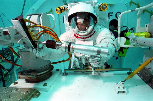 Astronaut Storey Musgrave conducts Hubble Space Telescope (HST) training in Marshall's Neutral Buoyancy Simulator (NBS).