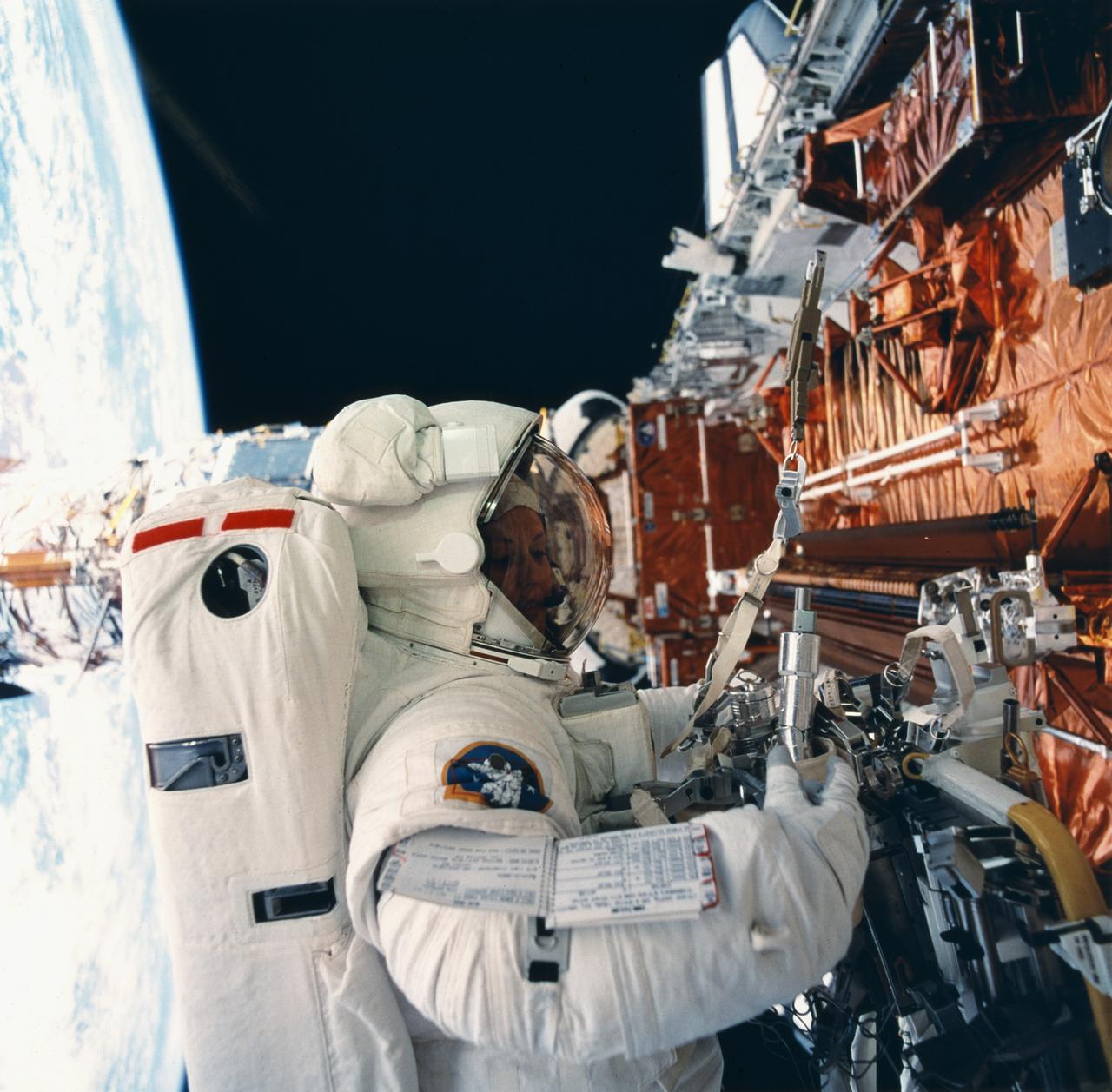This STS-61 onboard photo depicts Astronaut and mission specialist Kathryn Thornton performing the 2nd extra-vehicular activity (EVA) of the STS-61 mission. Thornton, along with astronaut and mission specialist Thomas Akers (out of frame), performed the task of replacing the solar arrays. The EVA lasted 6 hours and 35 minutes. Launched December 1, 1993 aboard the Space Shuttle Orbiter Endeavor, the STS-61 mission was solely dedicated to servicing the HST.
