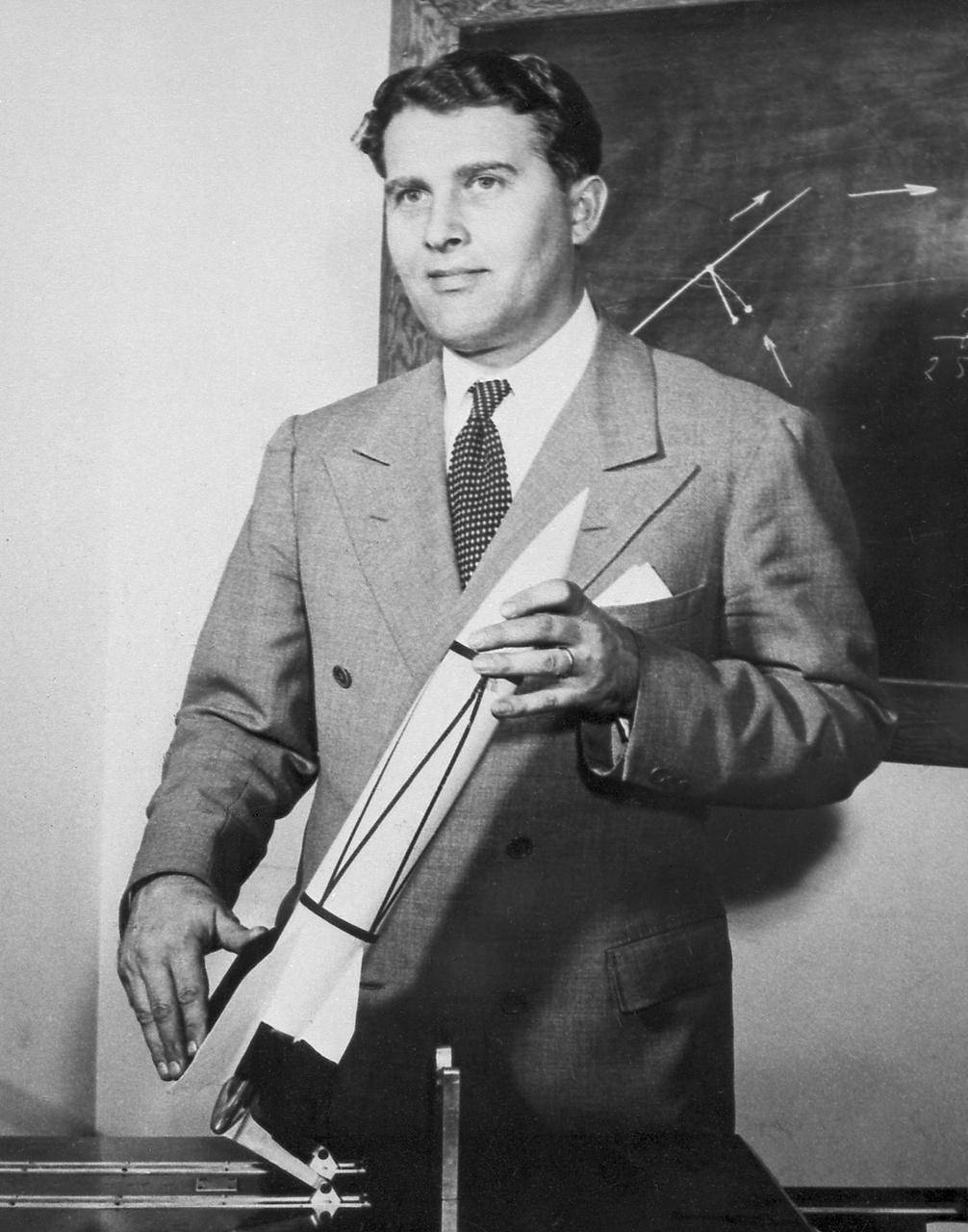 Dr. von Braun with a model of a V2 rocket.