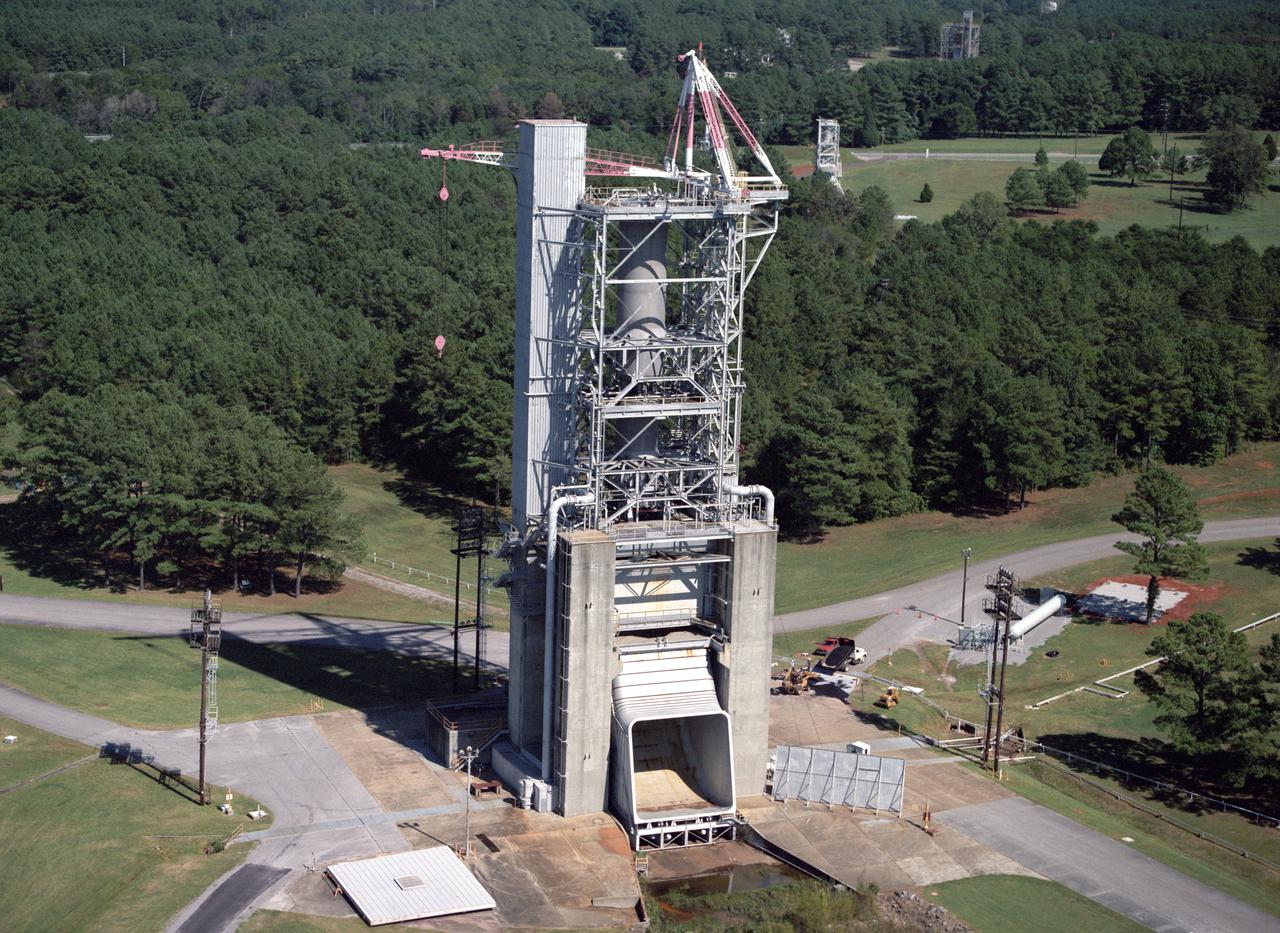 Marshall Space Flight Center's F-1 Engine Test Stand is shown in this picture. Constructed in 1963, the test stand is a vertical engine firing test stand, 239 feet in elevation and 4,600 square feet in area at the base, and was designed to assist in the development of the F-1 Engine. Capability is provided for static firing of 1.5 million pounds of thrust using liquid oxygen and kerosene. The foundation of the stand is keyed into the bedrock approximately 40 feet below grade.