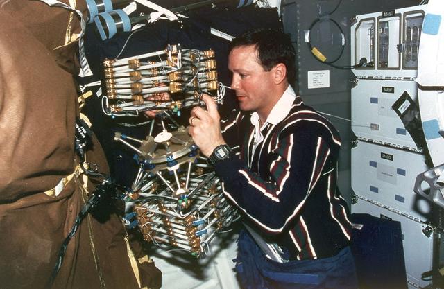 Astronaut Pierre J. Thuot, mission specialist, works with the Mid-deck 0-gravity Dynamics Experiment (MODE) aboard the Earth-orbiting Space Shuttle Columbia (STS-62). MODE studies the dynamics of liquids and skewed space structures in the microgravity environment.