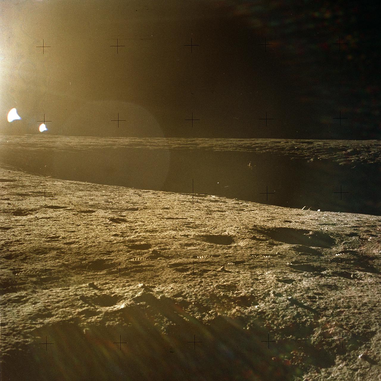 The second manned lunar landing mission, Apollo 12, launched from launch pad 39-A at Kennedy Space Center in Florida on November 14, 1969 via a Saturn V launch vehicle. The Saturn V vehicle was developed by the Marshall Space Flight Center (MSFC) under the direction of Dr. Wernher von Braun. Aboard Apollo 12 was a crew of three astronauts: Alan L. Bean, pilot of the Lunar Module (LM), Intrepid; Richard Gordon, pilot of the Command Module (CM), Yankee Clipper; and Spacecraft Commander Charles Conrad. The LM, Intrepid, landed astronauts Conrad and Bean on the lunar surface in what’s known as the Ocean of Storms while astronaut Richard Gordon piloted the CM, Yankee Clipper, in a parking orbit around the Moon. Lunar soil activities included the deployment of the Apollo Lunar Surface Experiments Package (ALSEP), finding the unmanned Surveyor 3 that landed on the Moon on April 19, 1967, and collecting 75 pounds (34 kilograms) of rock samples. This is the thirteenth of 25 images captured by the crew in attempt to provide a 360 degree Lunar surface scene. Apollo 12 safely returned to Earth on November 24, 1969.