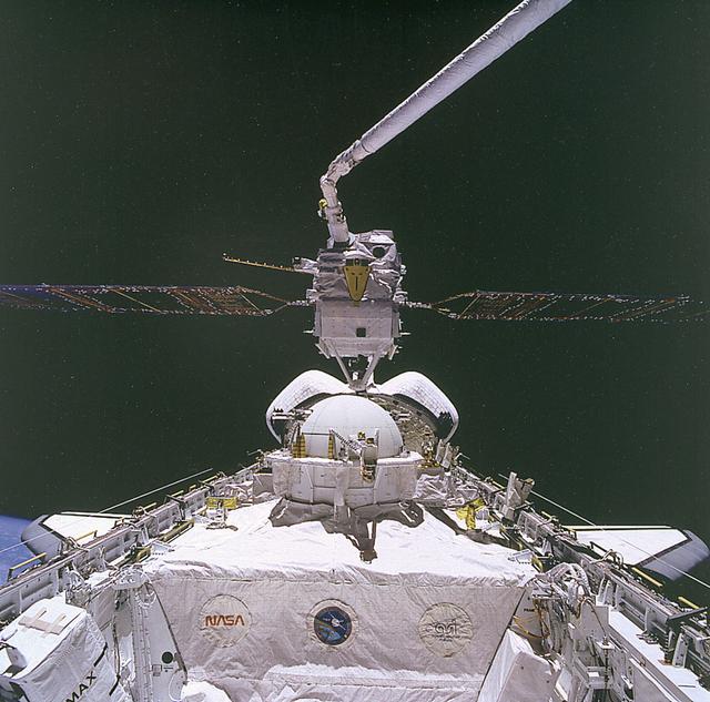 Space Shuttle Atlantis (STS-46) onboard photo of the Tethered Satellite System (TSS-1) on deployer boom. The Tethered Satellite System (TSS) was a cooperative development effort by the Italian Space Agency (ASI) and NASA made capable of deploying and retrieving a satellite which is attached by a wire tether from distances up to 100 km from the Orbiter. These free-flying satellites are used as observation platforms outside of the Orbiter.