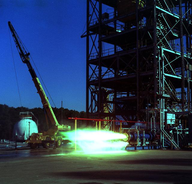 24 inch Hybrid motor test firing at Marshall's Test Stand 500. Liquid/gas are mixed with solid propellents to investigate materials, propellents, and nozzle stability characteristics. 