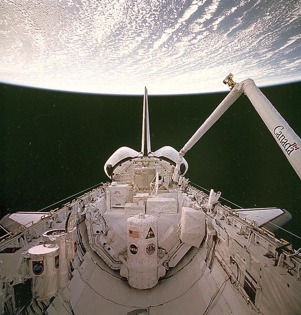 This is an STS-66 mission onboard photo showing the Remote Manipulator System (RMS) moving toward one of the solar science instruments for the third Atmospheric Laboratory for Applications and Science (ATLAS-3) mission in the cargo bay of the Orbiter Atlantis. During the ATLAS missions, international teams of scientists representing many disciplines combined their expertise to seek answers to complex questions about the atmospheric and solar conditions that sustain life on Earth. The ATLAS program specifically investigated how Earth's middle and upper atmospheres and climate are affected by by the sun and by products of industrial and agricultural activities on Earth. Thirteen ATLAS instruments supported experiments in atmospheric sciences, solar physics, space plasma physics, and astronomy. The instruments were mounted on two Spacelab pallets in the Space Shuttle payload bay. The ATLAS-3 mission continued a variety of atmospheric and solar studies, to improve understanding of the Earth's atmosphere and its energy input from the sun. A key scientific objective was to refine existing data on variations in the fragile ozone layer of the atmosphere. The Shuttle Orbiter Atlantis was launched on November 3, 1994 for the ATLAS-3 mission (STS-66). The ATLAS program was managed by the Marshall Space Flight Center.