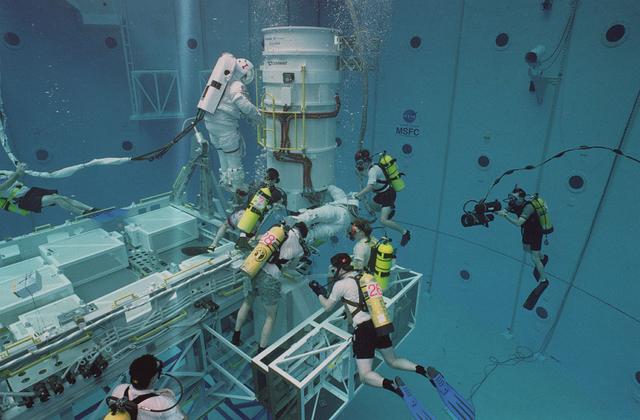 Astronaut Joe Lindquist and Kate Rupley conduct underwater testing on the International Space Station's power module in Marshall's Neutral Buoyancy Simulator (NBS).