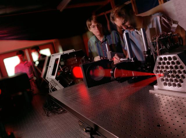 Scientists at Marshall's Adaptive Optics Lab demonstrate the Wave Front Sensor alignment using the Phased Array Mirror Extendible Large Aperture (PAMELA) optics adjustment. The primary objective of the PAMELA project is to develop methods for aligning and controlling adaptive optics segmented mirror systems. These systems can be used to acquire or project light energy. The Next Generation Space Telescope is an example of an energy acquisition system that will employ segmented mirrors. Light projection systems can also be used for power beaming and orbital debris removal. All segmented optical systems must be adjusted to provide maximum performance. PAMELA is an on going project that NASA is utilizing to investigate various methods for maximizing system performance.