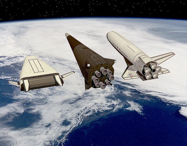 Artist John Frassanito's concept of three Single-Stage-to-Orbit (SSTO) Reusable Launch Vehicles (RLV's). Depicted from the left are: The Lockheed-Martin lifting body configuration that uses an integrated linear aerospike main engine; the McDornell Douglas vertical landing configuration; and the Rockwell wing body configuration that uses liquid oxygen and hydrogen bell engines.
