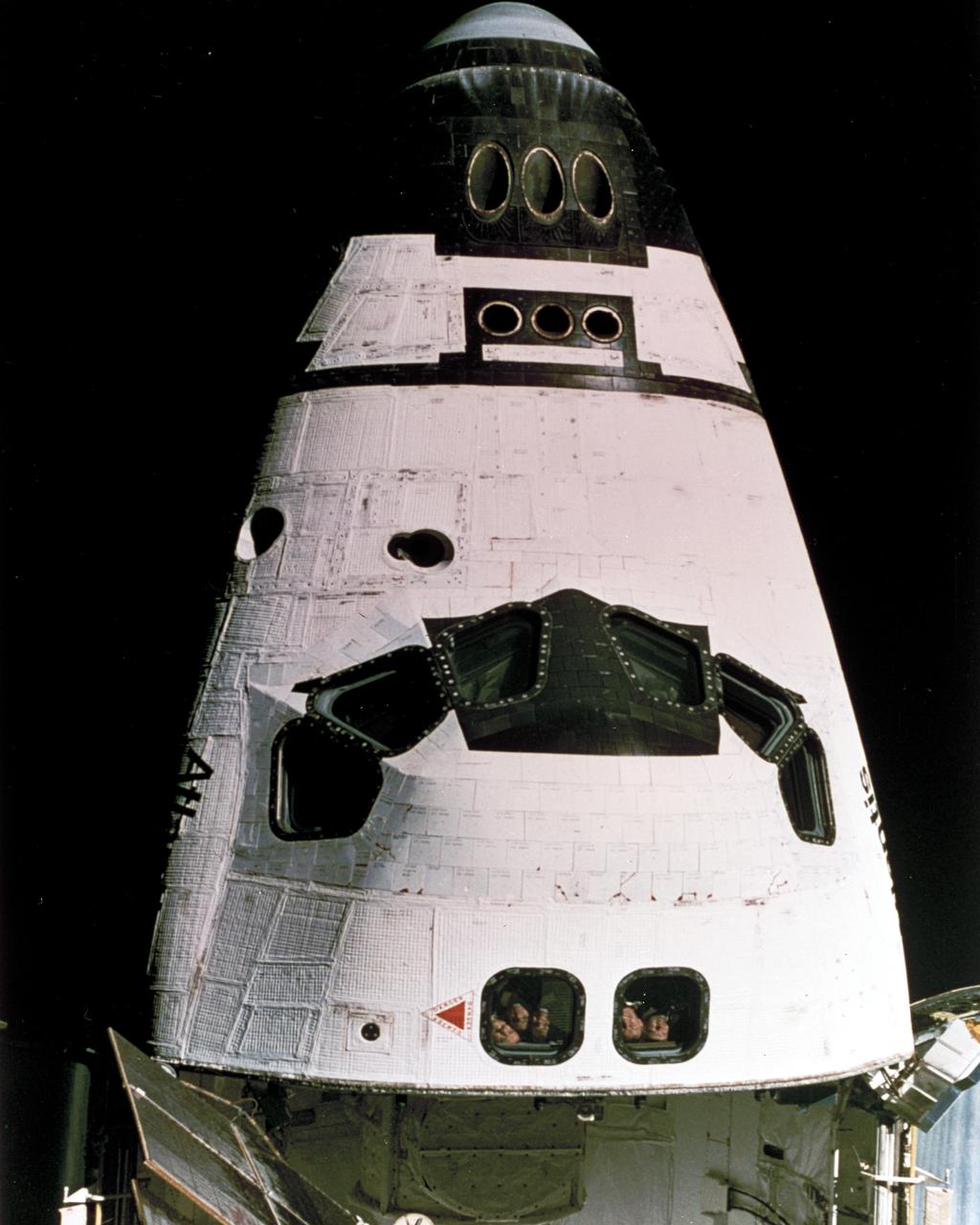 In this close-up of Space Shuttle Atlantis, the STS-74 crew is looking out the rear window. STS-74, launched on November 12, 1995, was the second Space Shuttle/Mir docking mission. Objectives accomplished included the delivery and installation of the Docking Module, making it possible for the Space Shuttle to dock easily with the Russian space station, Mir. The Orbiter Atlantis also delivered water, supplies, and equipment, including two new solar arrays to upgrade Mir, and returned to Earth on November 25, 1995 with experiment samples, equipment for repair and analysis, and products manufactured on the Station. 