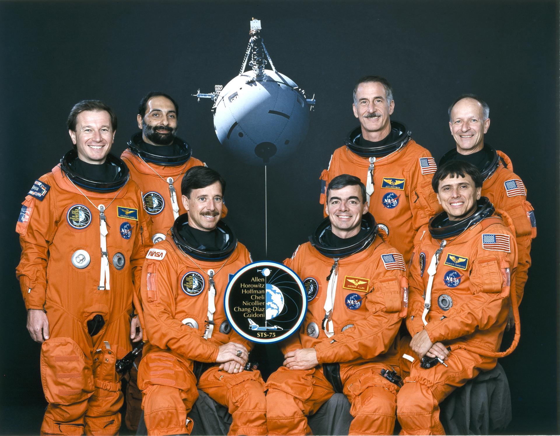 STS-75 crew portrait with astronauts in orange flight suits