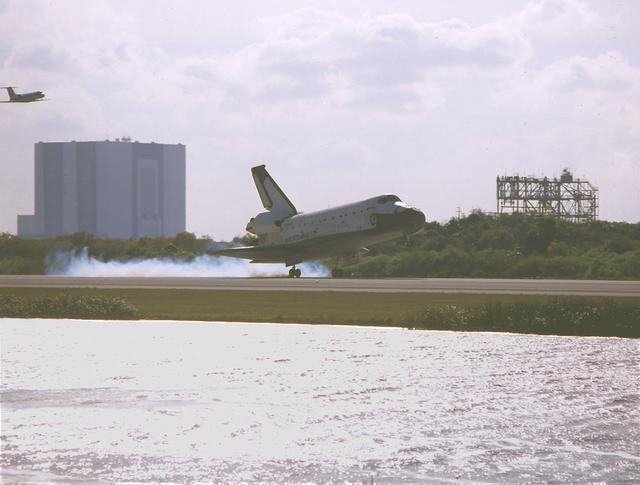 The Space Shuttle Orbiter Columbia's (STS-75) mission came to a close as the orbiter touched down on Runway 33 of Kennedy Space Center's Shuttle Landing Facility on March 9, 1996. Off to the right is the Vehicle Assembly Building and the Shuttle Training Aircraft (STA). The Mate/Demate Device (MDM) is at left. This Marshall Space Flight Center managed mission lasted 15 days and 17-hours, during which time the seven member crew conducted microgravity research with the U.S. Microgravity Payload (USMP-3), which flew for the third time. The other primary payload was the Tethered Satellite System (TSS-1R),a reflight from an earlier mission, but the satellite was lost when the tether broke just short of its fully deployed length of nearly 13 miles.