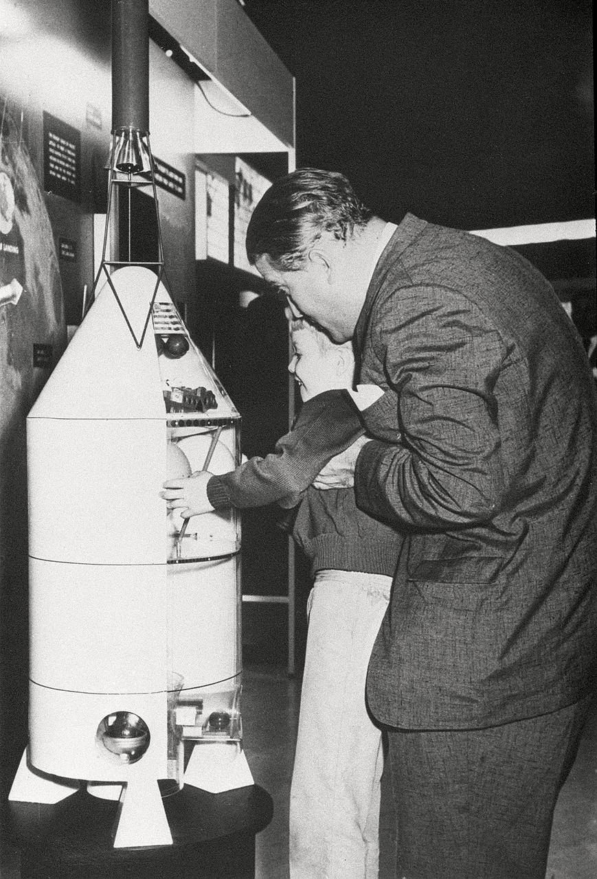 Dr. von Braun always promoted an increased emphasis on education in American culture. He is shown in this photograph with a young boy looking at a space-related exhibit.