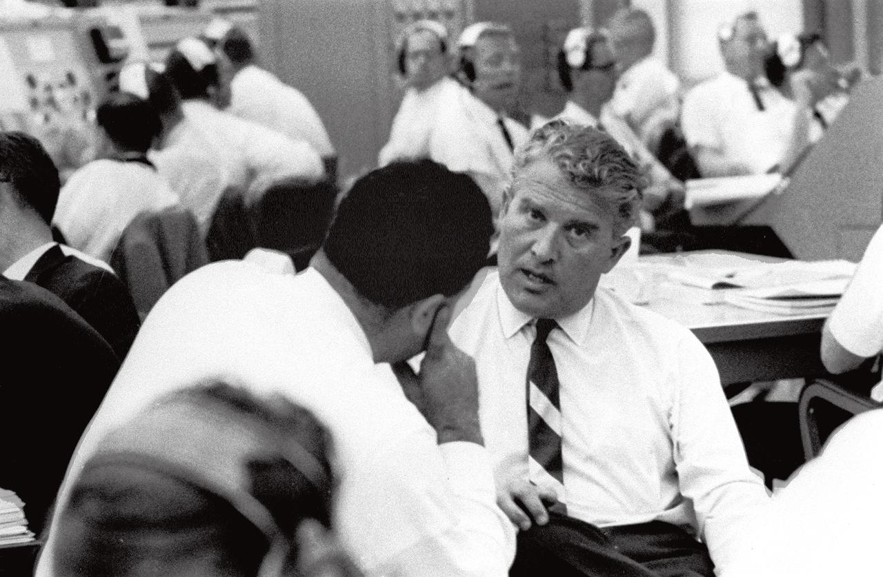 In this photograph at Kennedy Space Center (KSC) Complex 37 Control Center, Marshall Space Flight Center (MSFC) Director Wernher von Braun (right) talks with KSC's Rocco Petrone while awaiting the launch of SA-8 (Saturn I) on May 25, 1965. Petrone played key roles at KSC in the development of Saturn launch facilities before becoming the director of launch operations in 1966.
