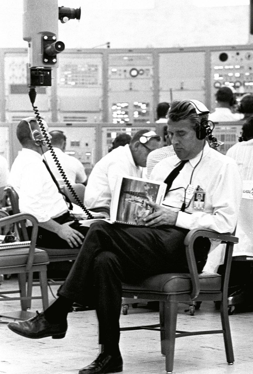Marshall Space Flight Center (MSFC) Director Wernher von Braun, seated near a periscope in Kennedy Space Center's Blockhouse 34, on May 28, 1964, looks over a flight manual while awaiting the launch of SA-6, the sixth Saturn I flight. Also known as Apollo Mission A-101, the launch marked the first flight of an Apollo spacecraft with a Saturn launch vehicle.