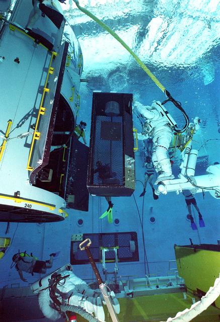 Astronauts Greg Harbaugh and Joe Tarner conduct Hubble Space Telescope training in Marshall's Neutral Buoyancy Simulator (NBS).