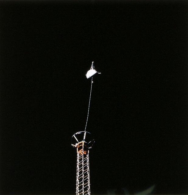 An STS-75 onboard photo of the Tethered Satellite System-1 Reflight (TSS-1R) atop its extended boom. The TSS-1R was a reflight of TSS-1, which was flown on the Space Shuttle in July/August, 1992. Building on the knowledge gained on the TSS-1 about tether dynamics, the TSS will circle the Earth at an altitude of 296 kilometers (184 miles), placing the tether system well within the rarefield, electrically charged layer of the atmosphere known as the ionosphere. The satellite was plarned to be deployed 20.7 kilometers (12.9 miles) above the Shuttle. The conducting tether, generating high voltage and electrical currents as it moves through the ionosphere cutting magnetic field lines, would allow scientists to examine the electrodynamics of a conducting tether system. In addition, the TSS would increase our understanding of physical processes in the near-Earth space environment, such as plasma waves and currents. The tether on the TSS broke as the Satellite was nearing the full extent of its 12.5 mile deployment from the Shuttle. The TSS was a cooperative development effort by the Italian Space Agency (ASI) and NASA, and was managed by scientists at the Marshall Space Flight Center.