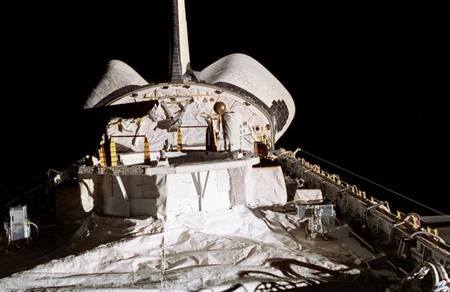 Onboard photo of space shuttle Columbia's (STS-75) open cargo bay carrying the United States Microgravity Payload-3 (USMP-3) at night.