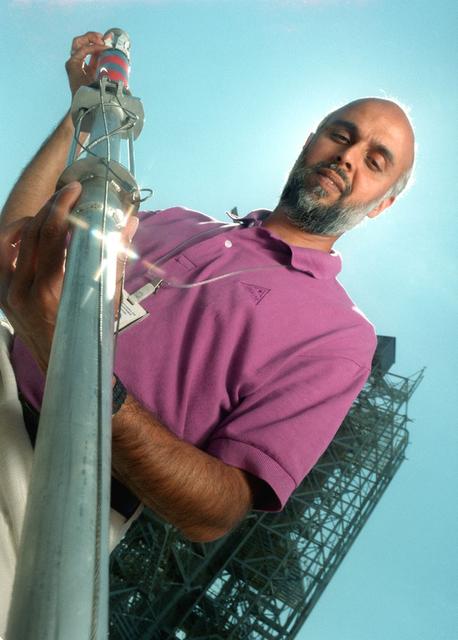 The dart and associated launching system was developed by engineers at MSFC to collect a sample of the aluminum oxide particles during the static fire testing of the Shuttle's solid rocket motor. The dart is launched through the exhaust and recovered post test. The particles are collected on sticky copper tapes affixed to a cylindrical shaft in the dart. A protective sleeve draws over the tape after the sample is collected to prevent contamination. The sample is analyzed under a scarning electron microscope under high magnification and a particle size distribution is determined. This size distribution is input into the analytical model to predict the radiative heating rates from the motor exhaust. Good prediction models are essential to optimizing the development of the thermal protection system for the Shuttle.