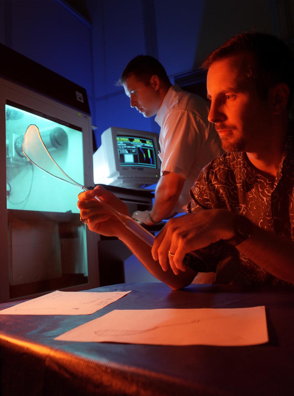 Marshall inventors Seth Lawson and Stanley Smeltzer display a pair of obstetrical forceps they designed. The forceps, made from composite space-age materials, measure the force applied during instrument-assisted delivery. The new forceps will help medical students get a feel for instrument-assisted deliveries before entering practice.