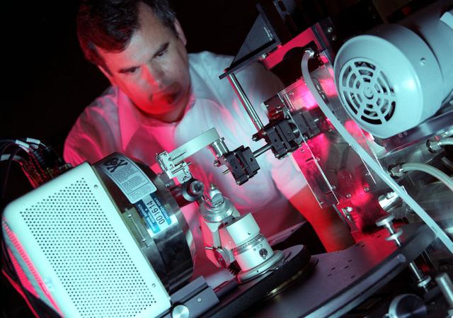 NASA scientist, in the Space Sciences lab at Marshall, works with capillary optics that generate more intense X-rays than conventional sources. This capability is useful in studying the structure of important proteins.